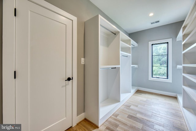 spacious closet with light wood finished floors and visible vents