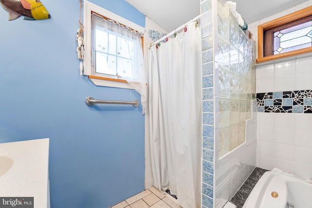 bathroom with tile patterned flooring and shower / tub combo