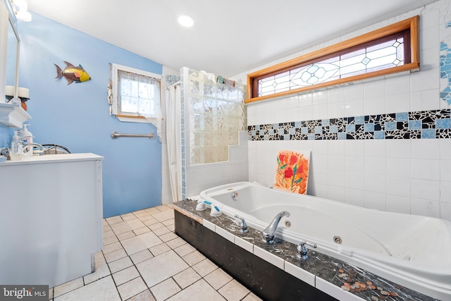 bathroom featuring tiled tub and tile patterned flooring