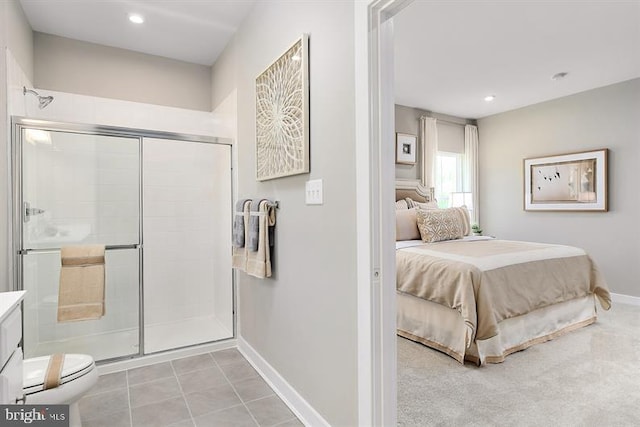 interior space with vanity, tile patterned flooring, a shower with door, and toilet