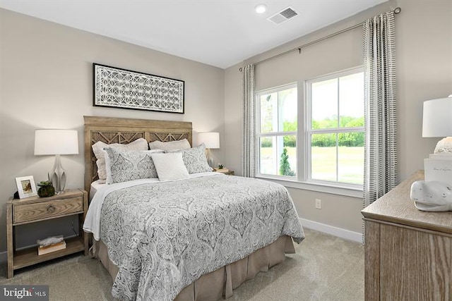 carpeted bedroom with multiple windows