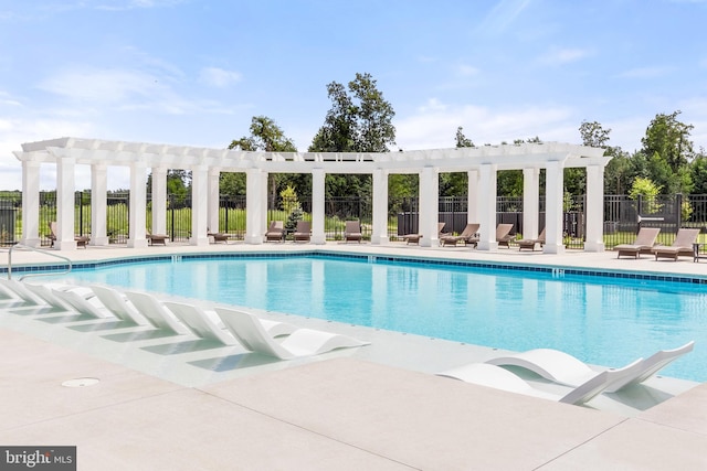 view of swimming pool featuring a pergola