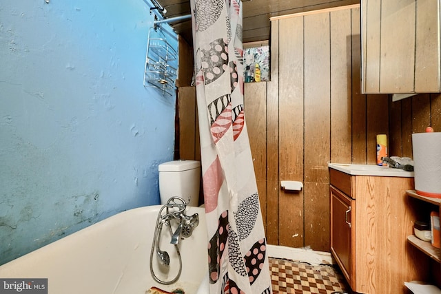 bathroom featuring vanity and wood walls