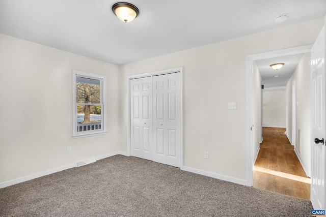 unfurnished bedroom featuring carpet floors and a closet