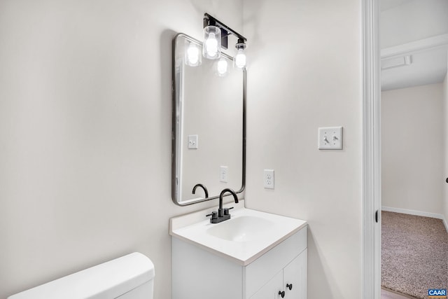 bathroom featuring vanity and toilet