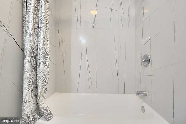 bathroom featuring shower / bathtub combination with curtain