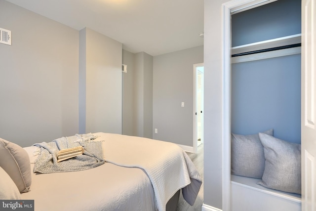 bedroom with hardwood / wood-style flooring and a closet