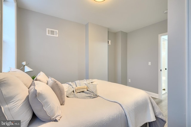 bedroom with hardwood / wood-style floors