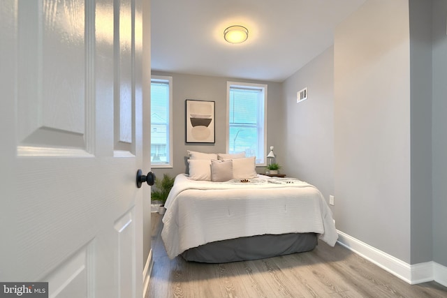 bedroom with hardwood / wood-style flooring