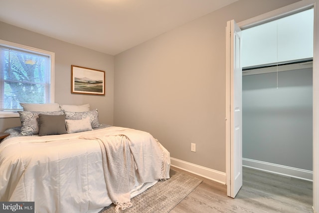 bedroom featuring a closet and light hardwood / wood-style flooring