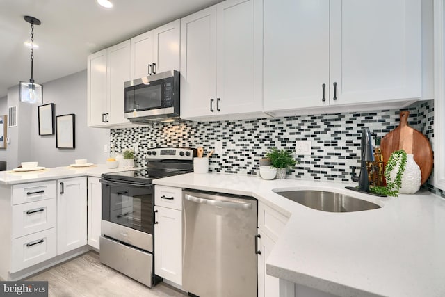 kitchen featuring white cabinets, stainless steel appliances, and sink