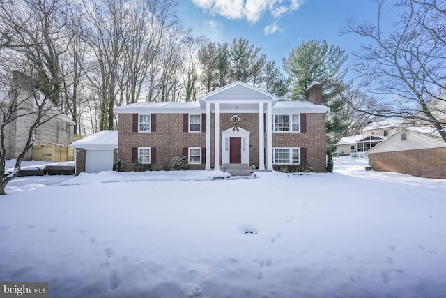 greek revival inspired property featuring a garage