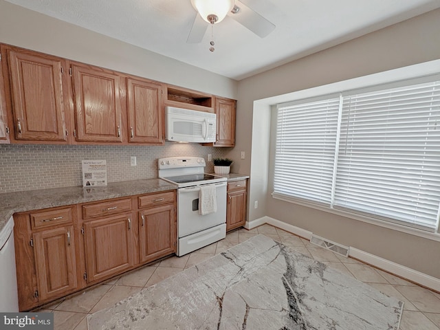 kitchen with ceiling fan, white appliances, light tile patterned floors, and tasteful backsplash