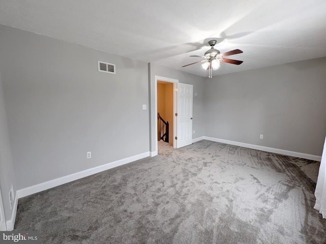 empty room with ceiling fan and carpet flooring