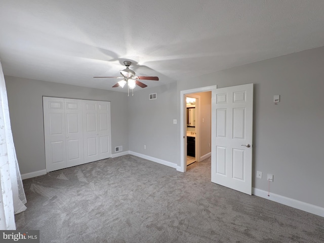 unfurnished bedroom with carpet floors, a closet, and ceiling fan