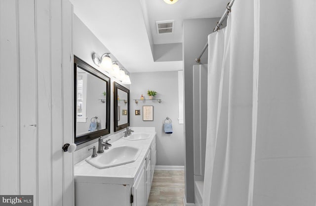 bathroom featuring vanity, a shower with curtain, and hardwood / wood-style floors