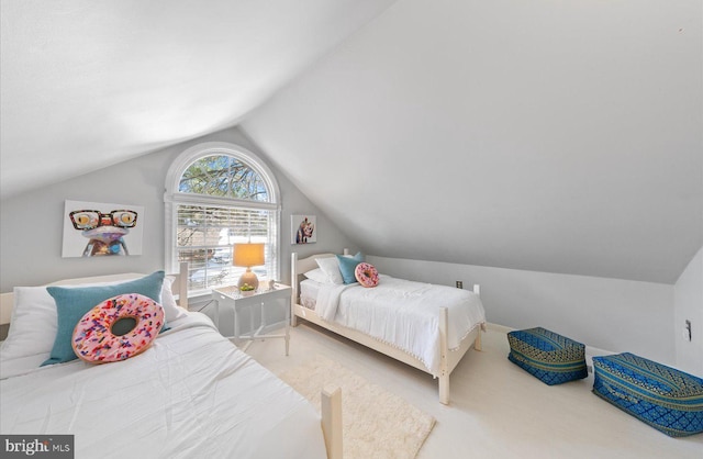 bedroom featuring carpet and vaulted ceiling