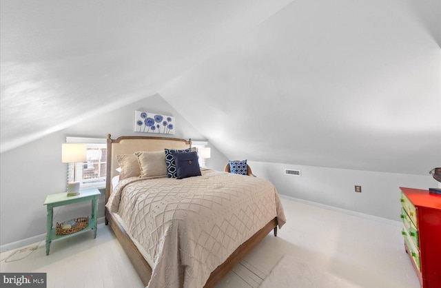 bedroom with lofted ceiling