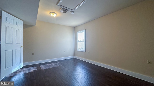 unfurnished room with dark wood-type flooring