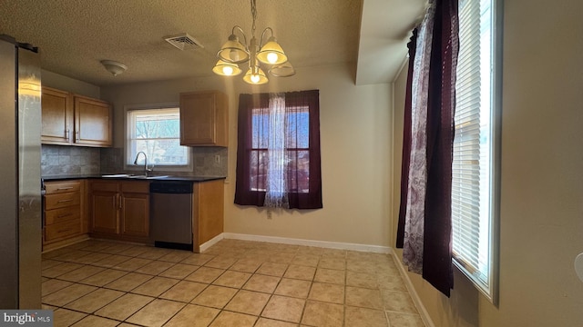 kitchen featuring sink, tasteful backsplash, a notable chandelier, light tile patterned flooring, and stainless steel appliances