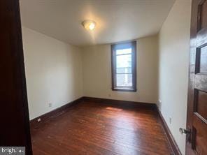 unfurnished room with dark hardwood / wood-style floors