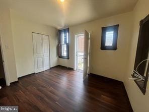 unfurnished bedroom featuring dark hardwood / wood-style floors