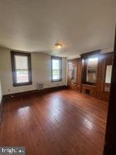 unfurnished living room with dark hardwood / wood-style flooring