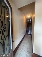 hallway with light tile patterned floors