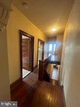 hall with dark hardwood / wood-style floors