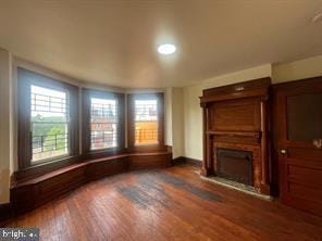 unfurnished living room with dark hardwood / wood-style flooring