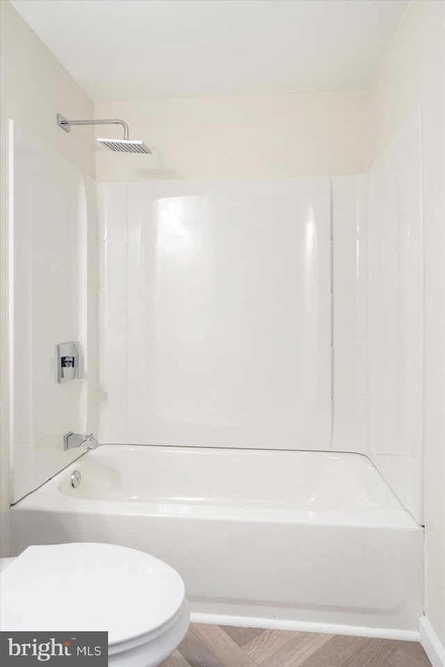 bathroom featuring toilet and shower / washtub combination