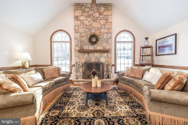 living room with hardwood / wood-style floors, a fireplace, high vaulted ceiling, and a healthy amount of sunlight