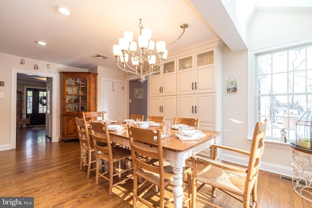 dining room featuring dark wood-type flooring and an inviting chandelier