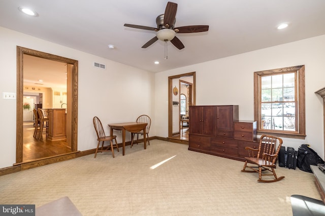 sitting room featuring carpet floors and ceiling fan