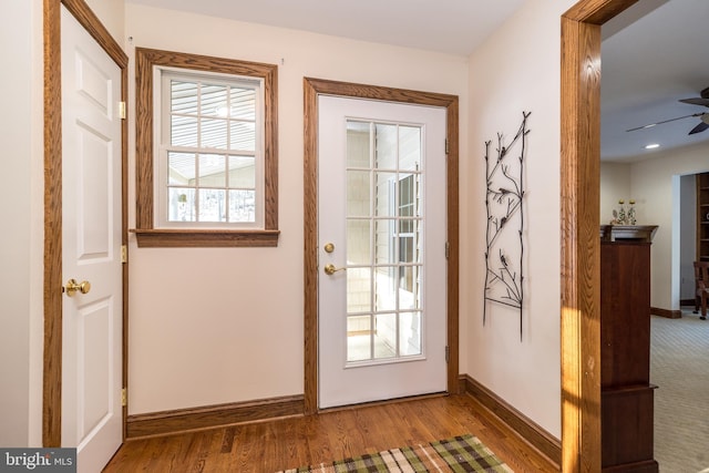 doorway featuring wood-type flooring and ceiling fan