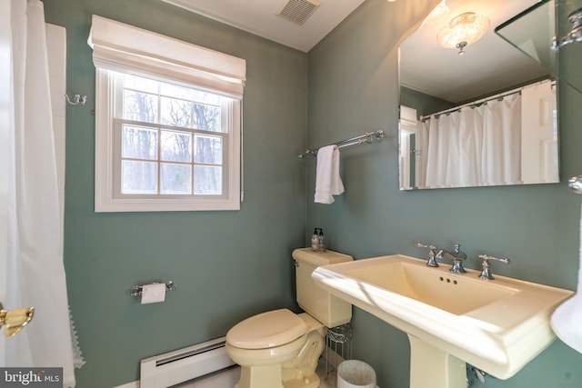 bathroom with baseboard heating, toilet, and sink