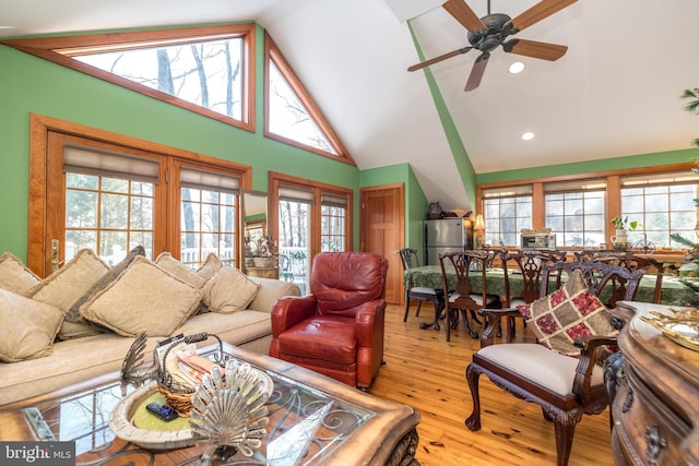 living room with a wealth of natural light, ceiling fan, and light wood-type flooring