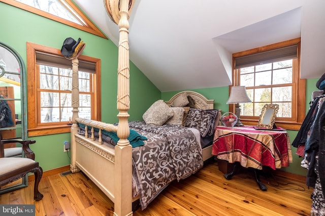 bedroom featuring lofted ceiling and light hardwood / wood-style flooring