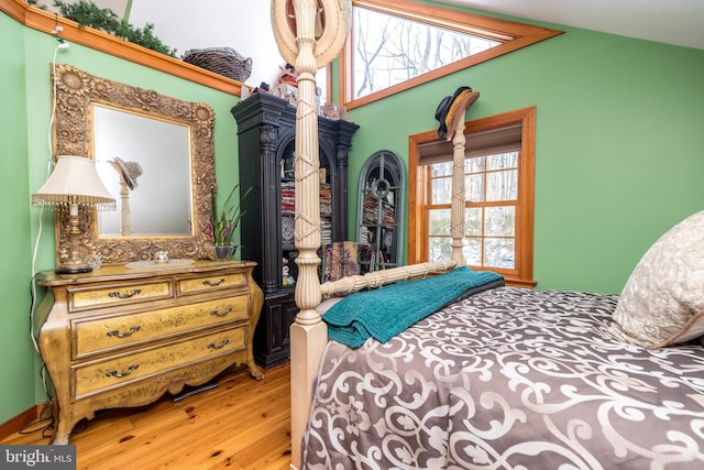 bedroom with lofted ceiling and hardwood / wood-style floors