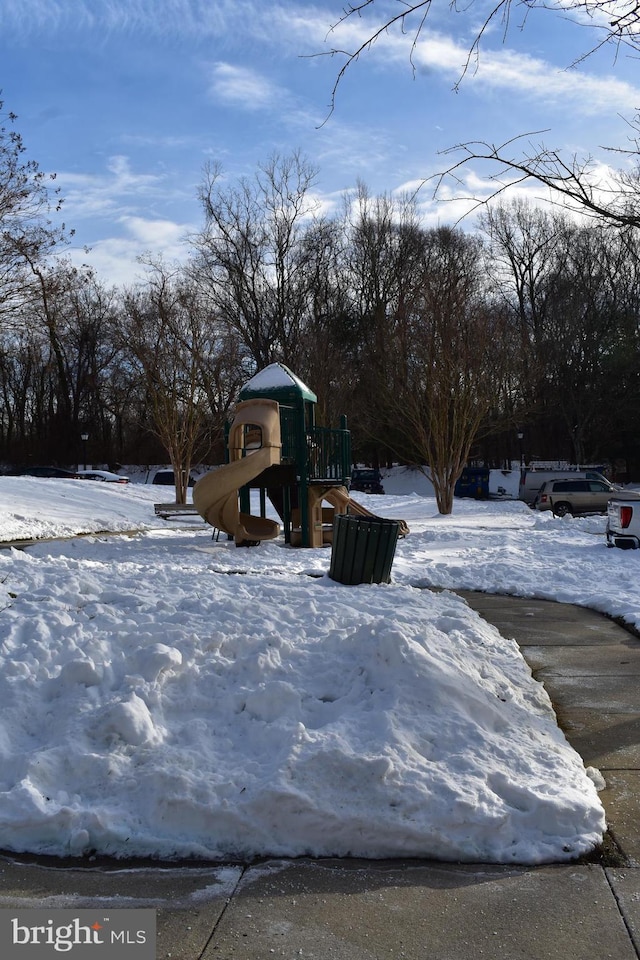 yard covered in snow with a playground