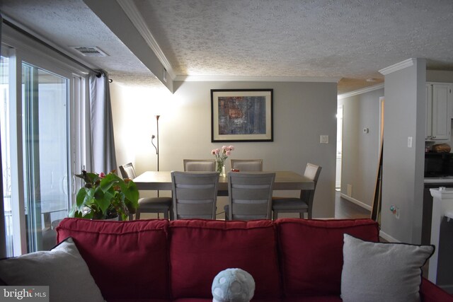 living room with a textured ceiling and ornamental molding