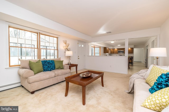 living room featuring light colored carpet and a baseboard radiator