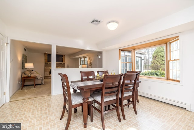 dining space featuring a baseboard heating unit