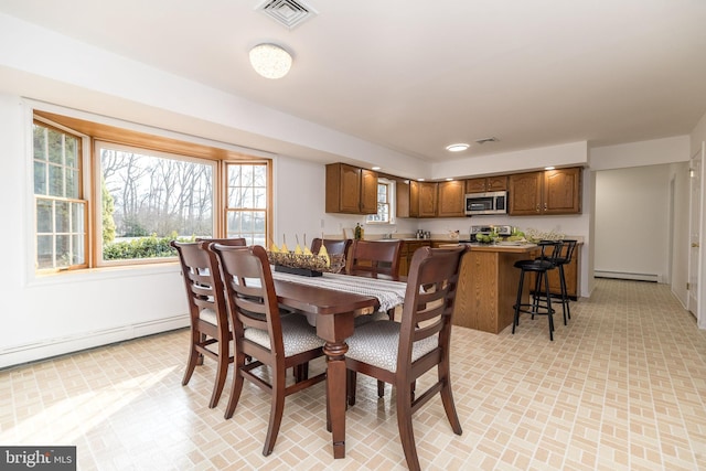 dining area featuring a baseboard heating unit