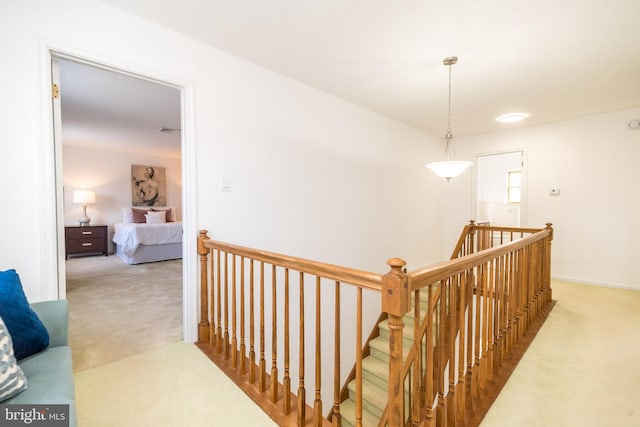 corridor featuring light colored carpet