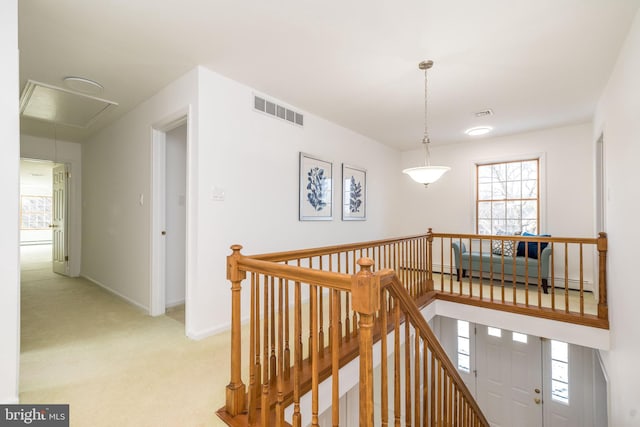 corridor featuring light carpet and a baseboard heating unit