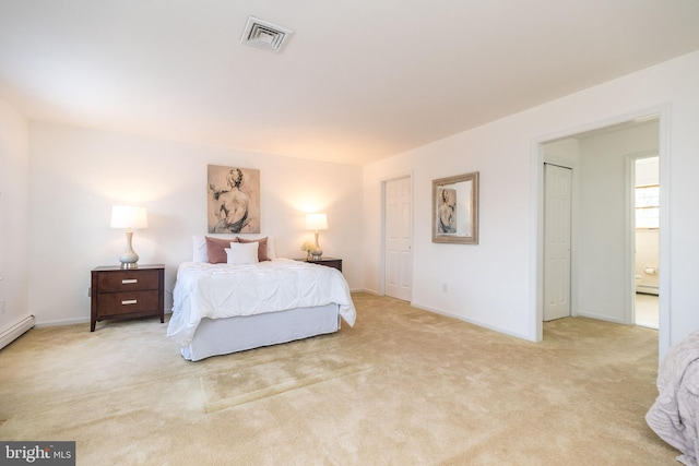 bedroom featuring light colored carpet and ensuite bath