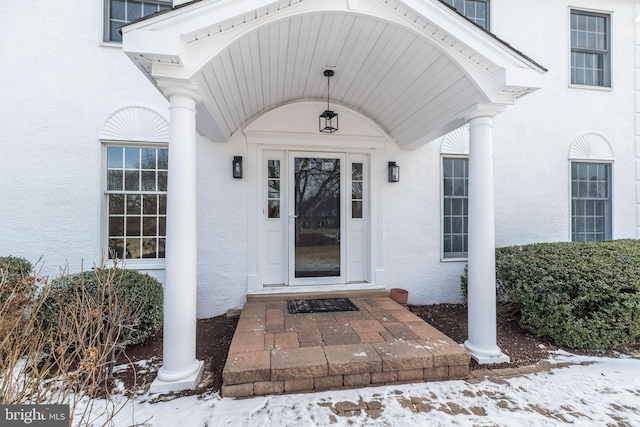 view of snow covered property entrance