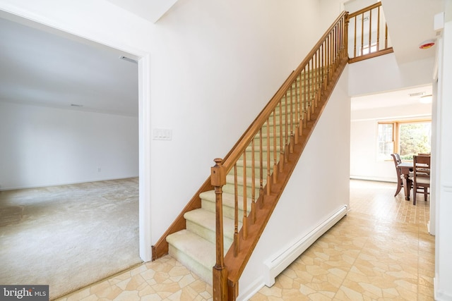 staircase featuring carpet floors and a baseboard heating unit