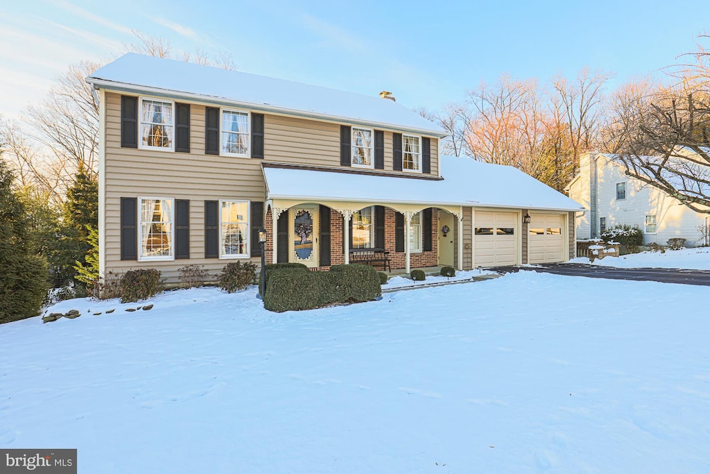 view of front of house featuring covered porch and a garage